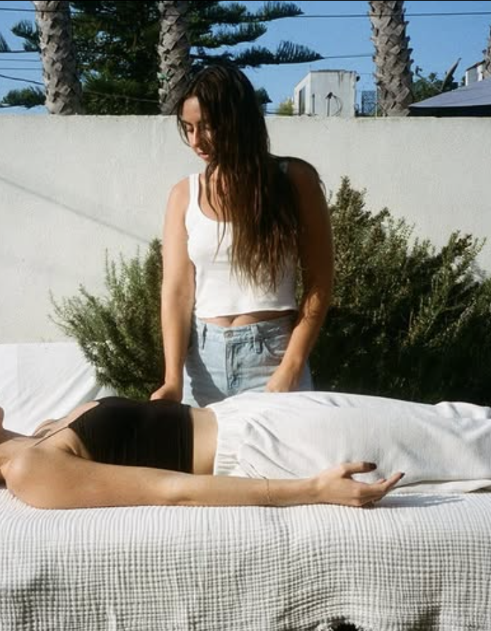 Dr. Sarah Viducic performing acupuncture on a client outdoors